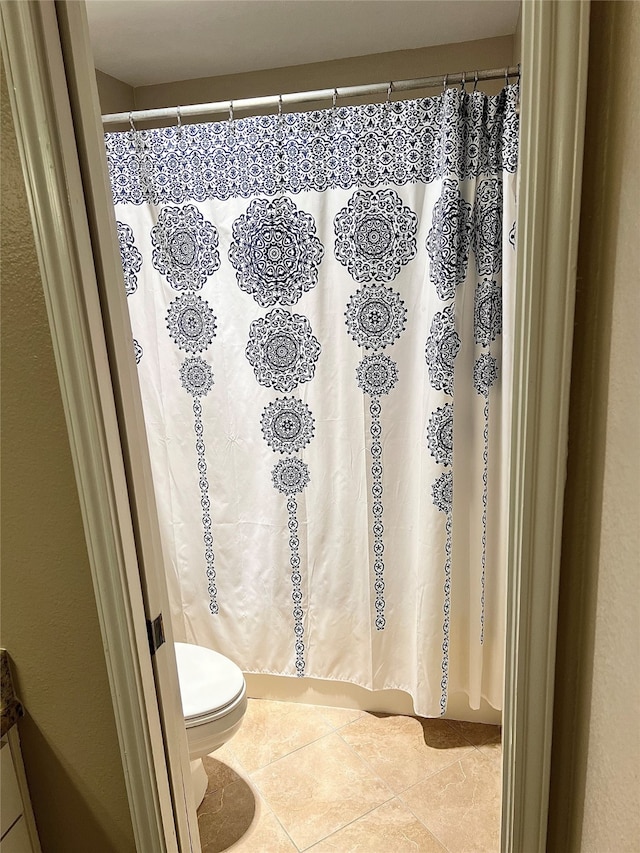 bathroom with toilet and tile patterned floors