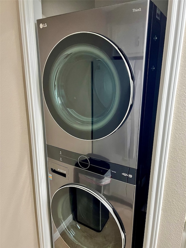 laundry area featuring stacked washer / drying machine