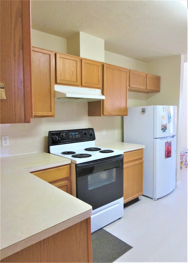 kitchen with white appliances and a textured ceiling