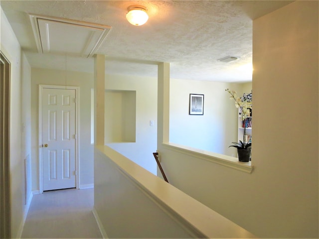 corridor featuring a textured ceiling