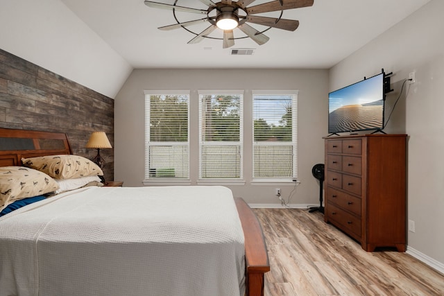 bedroom with light hardwood / wood-style flooring, ceiling fan, and lofted ceiling