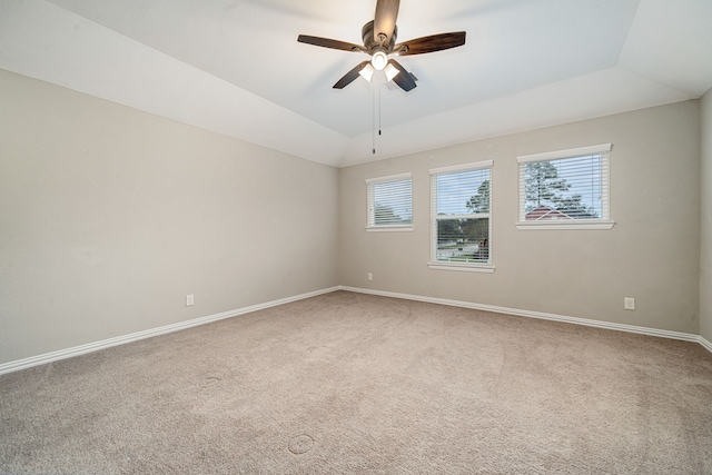 carpeted spare room with ceiling fan and vaulted ceiling