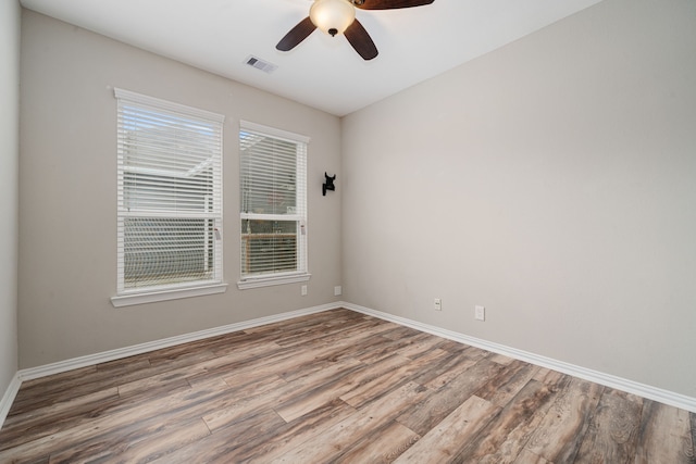 spare room featuring hardwood / wood-style flooring and ceiling fan