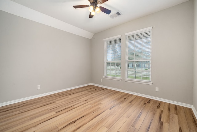 empty room with ceiling fan and light wood-type flooring