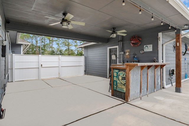 view of patio / terrace with ceiling fan and exterior bar