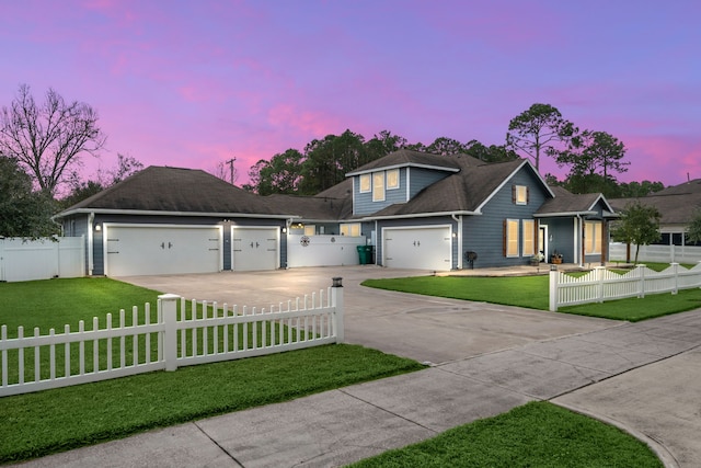 view of front facade with a garage and a yard