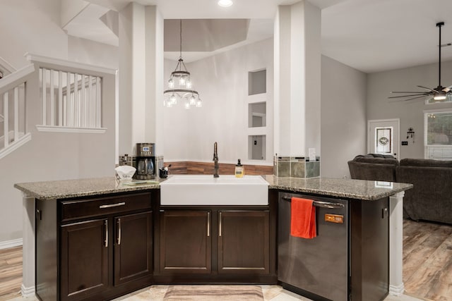 kitchen with stainless steel dishwasher, dark brown cabinets, sink, pendant lighting, and light hardwood / wood-style floors