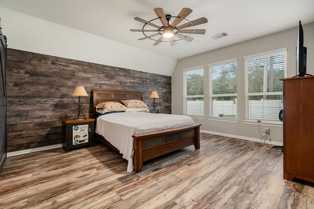 bedroom featuring ceiling fan, vaulted ceiling, and hardwood / wood-style flooring