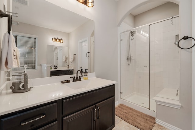 bathroom featuring vanity and a shower with shower door