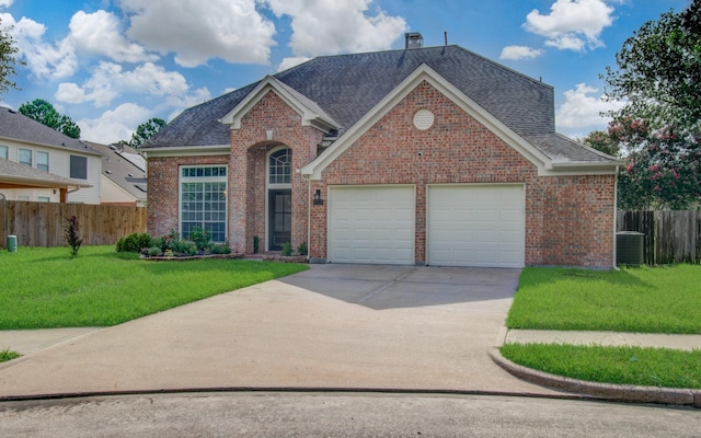 view of front property with a front yard, a garage, and cooling unit