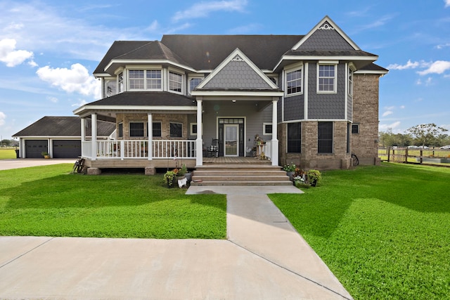 victorian-style house featuring a porch, an attached garage, brick siding, driveway, and a front lawn