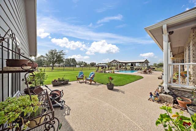 view of patio with a fire pit and a gazebo