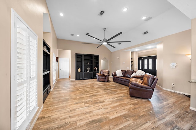 living room with light wood-type flooring, ceiling fan, and vaulted ceiling