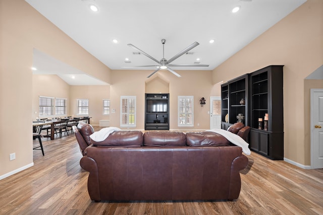 living room with ceiling fan and light wood-type flooring