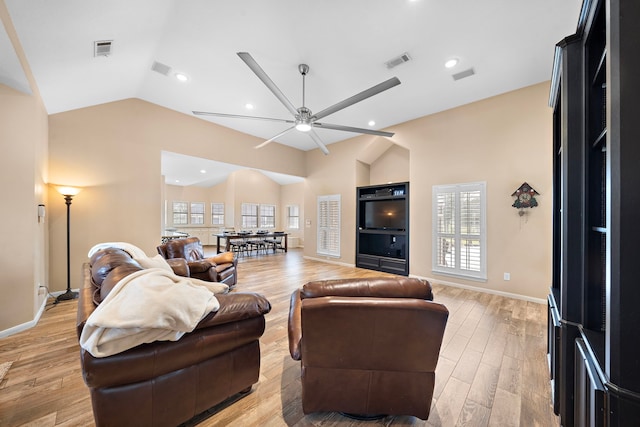 living room with light wood-type flooring, lofted ceiling, and ceiling fan