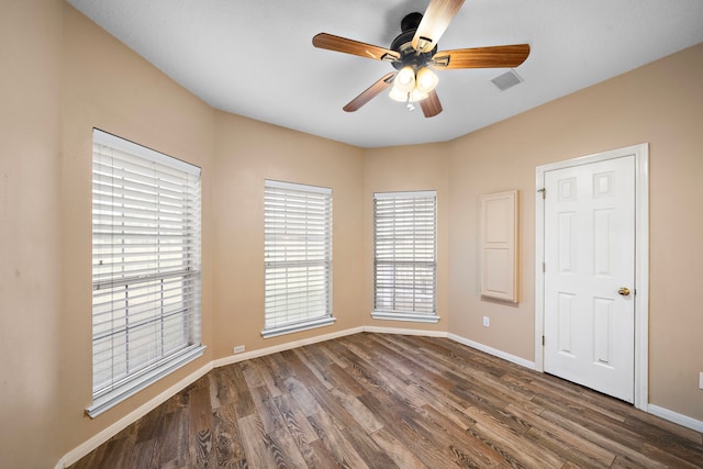 empty room featuring ceiling fan and dark hardwood / wood-style flooring