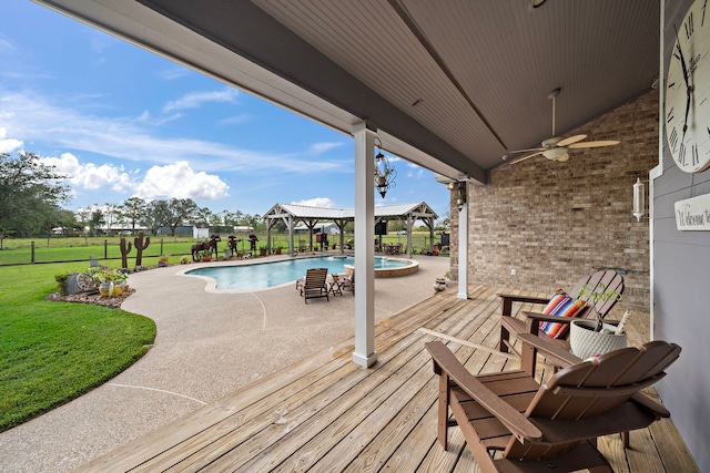 wooden deck with a lawn, ceiling fan, and a patio area