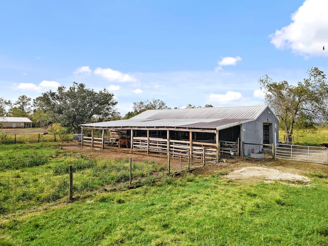 view of horse barn featuring a rural view