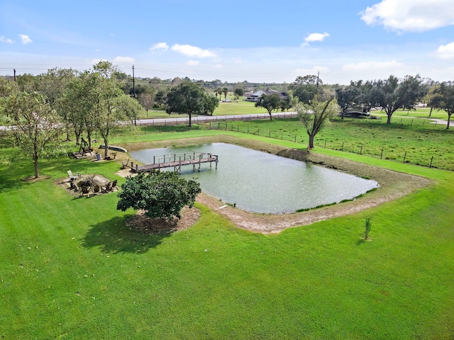 view of home's community with a yard and a water view