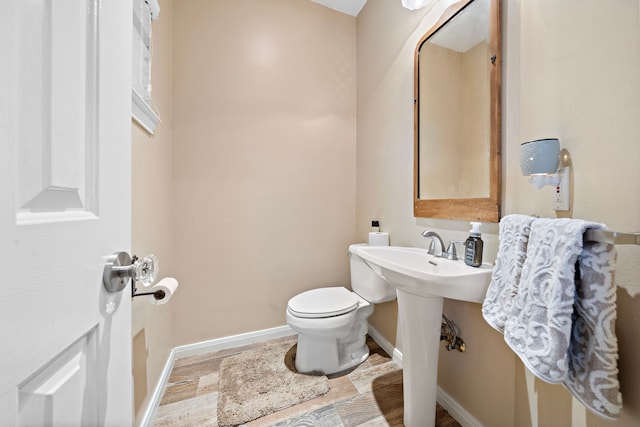 bathroom featuring toilet and hardwood / wood-style floors