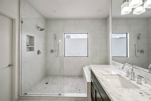 bathroom with vanity and a tile shower