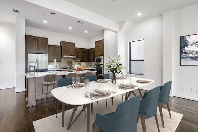 dining area with dark wood-type flooring and sink