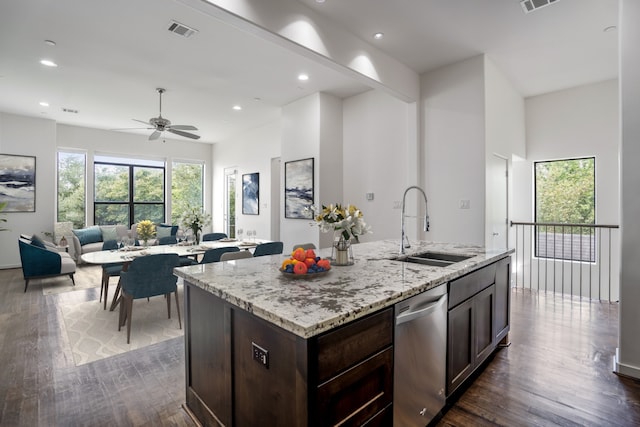 kitchen with an island with sink, sink, dark wood-type flooring, and dishwasher