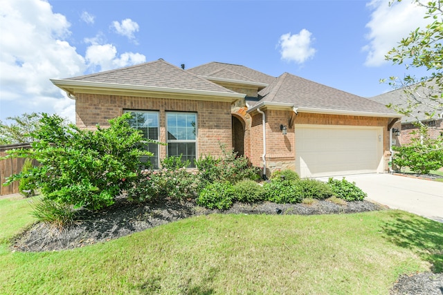 view of front of house with a garage and a front yard