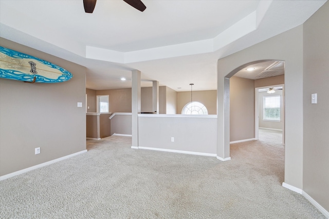 carpeted spare room featuring ceiling fan