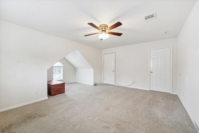 bonus room with light carpet and ceiling fan