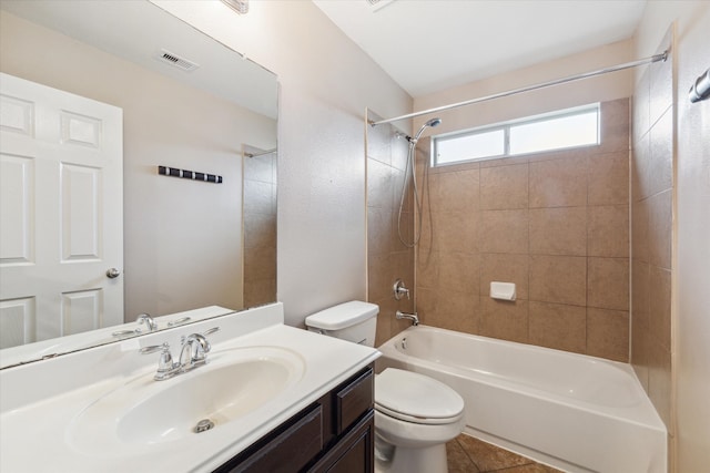 full bathroom featuring vanity, tile patterned floors, toilet, and tiled shower / bath combo