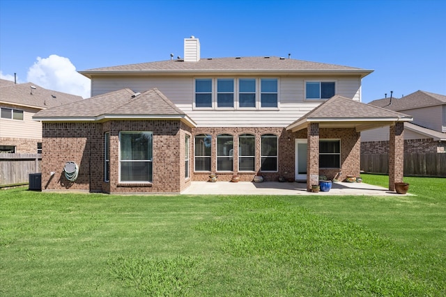 back of property featuring a yard and a patio area