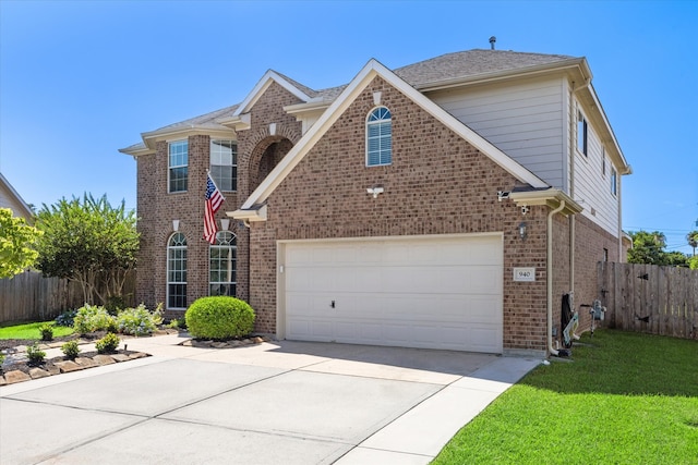 view of property featuring a garage and a front yard