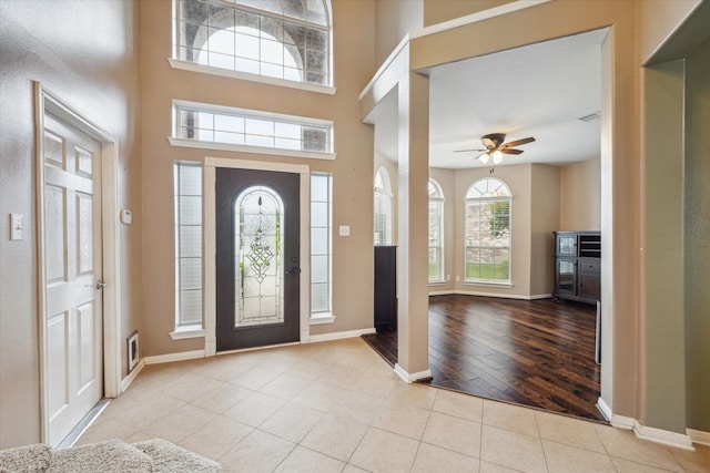 foyer featuring ceiling fan, a wealth of natural light, and light hardwood / wood-style floors