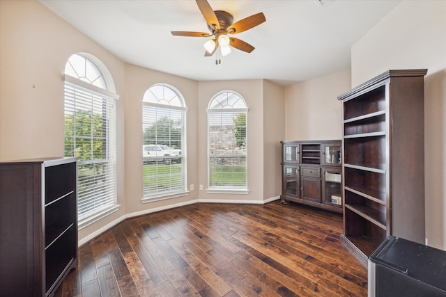 unfurnished office with dark wood-type flooring and ceiling fan