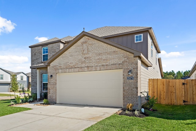 view of front of property with a front yard and a garage