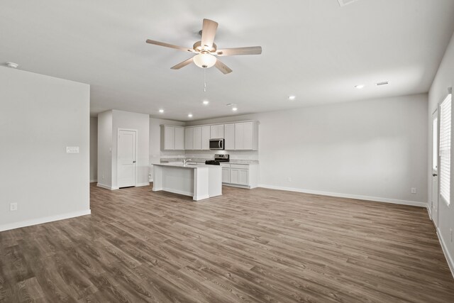 unfurnished living room with hardwood / wood-style floors and ceiling fan