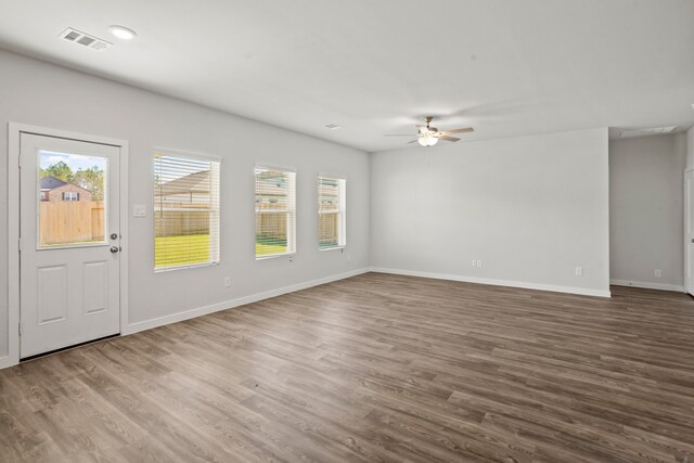 interior space featuring ceiling fan, a wealth of natural light, and wood-type flooring