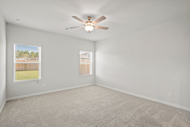 carpeted empty room featuring ceiling fan