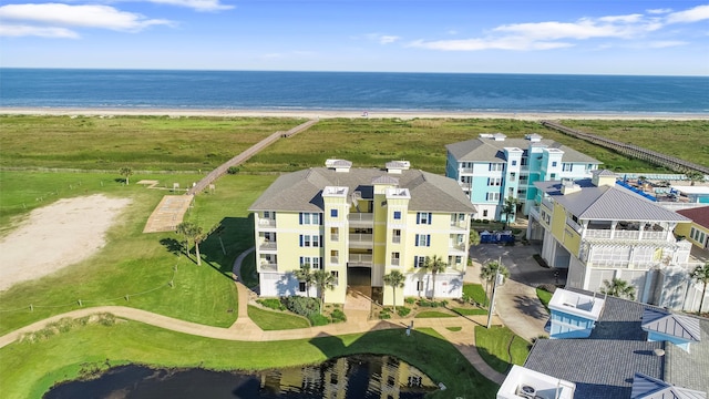 bird's eye view with a water view and a beach view