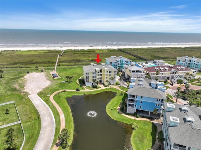 drone / aerial view with a water view and a beach view