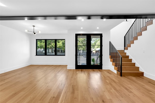 foyer featuring french doors, a wealth of natural light, and light hardwood / wood-style floors