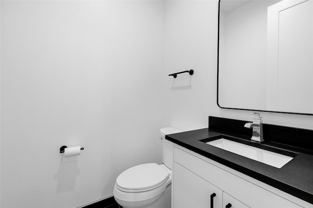 bathroom featuring toilet and vanity