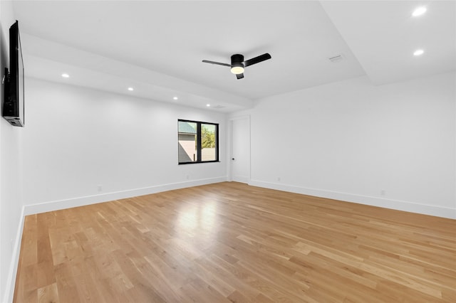 spare room with light wood-type flooring and ceiling fan