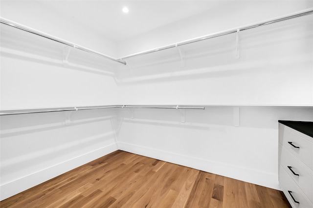 walk in closet featuring light hardwood / wood-style flooring