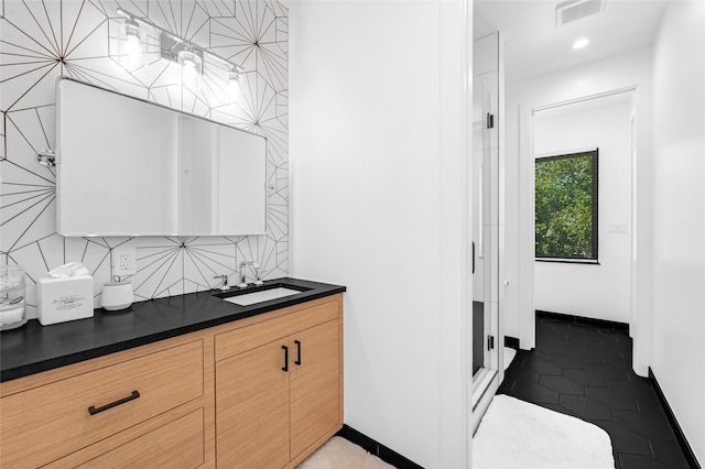 bathroom featuring tasteful backsplash and vanity