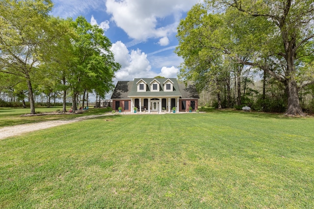 cape cod house featuring a front lawn