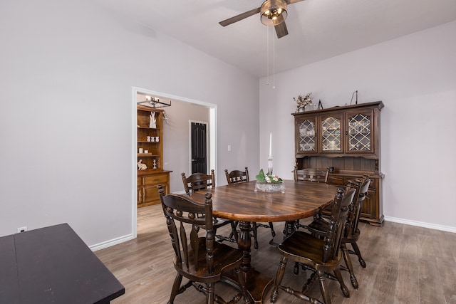 dining area with hardwood / wood-style flooring and ceiling fan