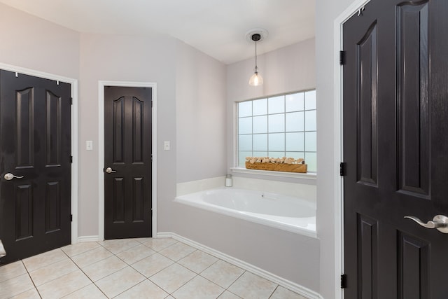 bathroom with a bath and tile patterned floors