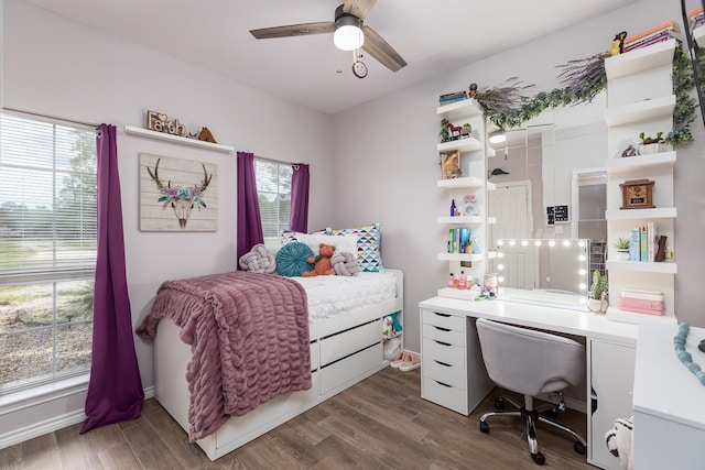 bedroom with dark hardwood / wood-style floors and ceiling fan